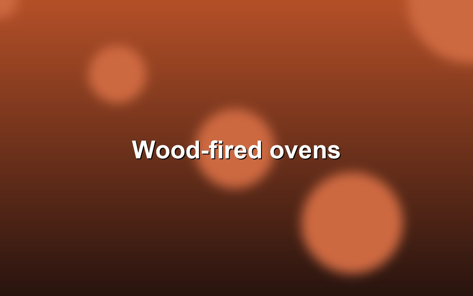 The wood-fired ovens glowing at the back of the bakery